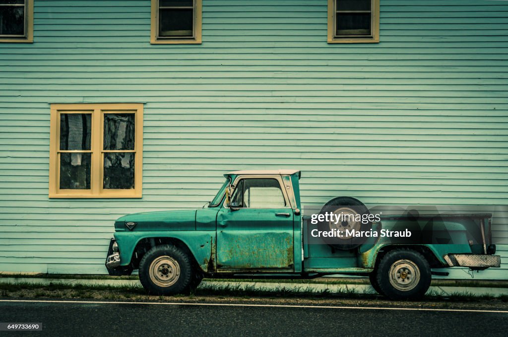 Old Green Truck against Green Building