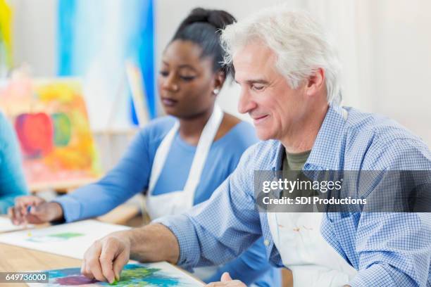 active senior man in art class - pastel crayon stock pictures, royalty-free photos & images