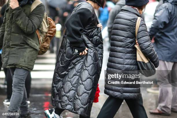 Guest wears a black puffer coat, outside the Comme des Garcons show, during Paris Fashion Week Womenswear Fall/Winter 2017/2018, on March 4, 2017 in...