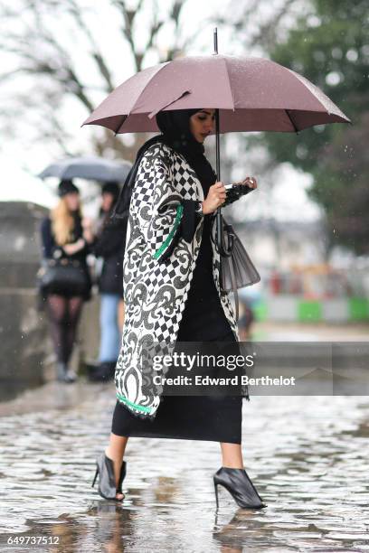 Guest is seen, outside the Elie Saab show, during Paris Fashion Week Womenswear Fall/Winter 2017/2018, on March 4, 2017 in Paris, France.