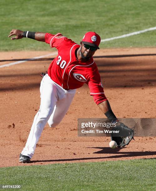 Arismendy Alcantara of the Cincinnati Reds fields a ground ball in the ninth inning against the Los Angeles Angels during the spring training game at...