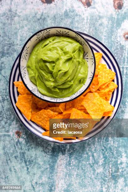 tortilla chips with guacamole - nachos guacamole stock pictures, royalty-free photos & images