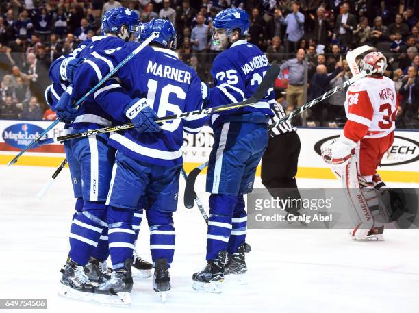 Alexey Marchenko of the Toronto Maple Leafs celebrates his goal on Petr Mrazek of the Detroit Red Wings with teammates Mitch Marner and James van...