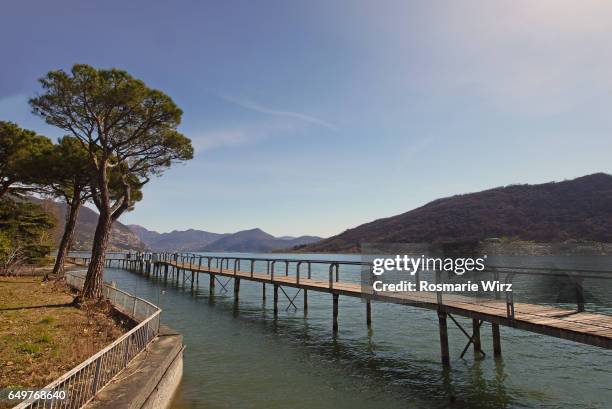 wooden footbridge on lake iseo - sarnico stock pictures, royalty-free photos & images