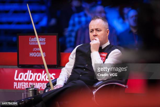John Higgins of Scotland reacts during the first round match against Ding Junhui of China on day three of 2017 Ladbrokes Players Championship at...