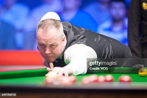 John Higgins of Scotland plays a shot during the first round match against Ding Junhui of China on day three of 2017 Ladbrokes Players Championship...