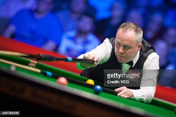 John Higgins of Scotland plays a shot during the first round match against Ding Junhui of China on day three of 2017 Ladbrokes Players Championship...
