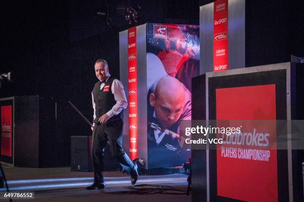 John Higgins of Scotland reacts during the first round match against Ding Junhui of China on day three of 2017 Ladbrokes Players Championship at...