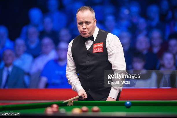 John Higgins of Scotland reacts during the first round match against Ding Junhui of China on day three of 2017 Ladbrokes Players Championship at...