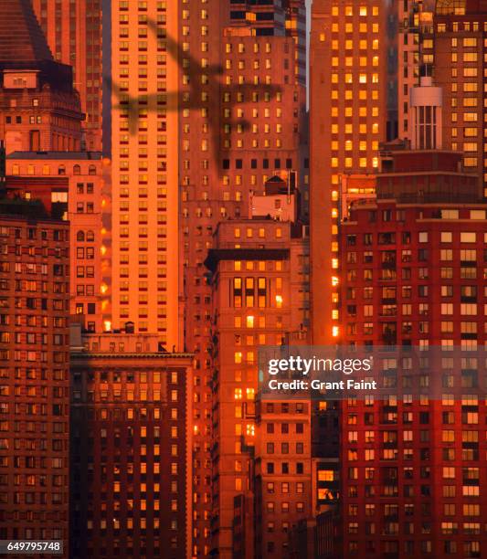 shadow on group of buildings. - airplane shadow stock pictures, royalty-free photos & images