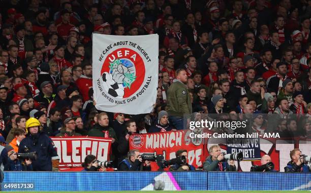 Bayern Munich fans hold up a banner protesting about UEFA during the UEFA Champions League Round of 16 second leg match between Arsenal FC and FC...