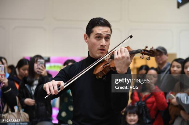 English violinist Charlie Siem performs at a shopping mall on International Women's Day on March 8, 2017 in Nanjing, Jiangsu Province of China.