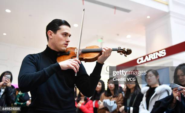 English violinist Charlie Siem performs at a shopping mall on International Women's Day on March 8, 2017 in Nanjing, Jiangsu Province of China.