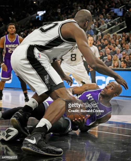 Anthony Tolliver of the Sacramento Kings looks to pass as he is guarded by Joel Anthony of the San Antonio Spurs at AT&T Center on March 8, 2017 in...