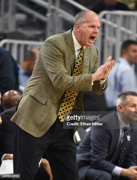 Head coach Tad Boyle of the Colorado Buffaloes gestures to his players during a first-round game of the Pac-12 Basketball Tournament against the...