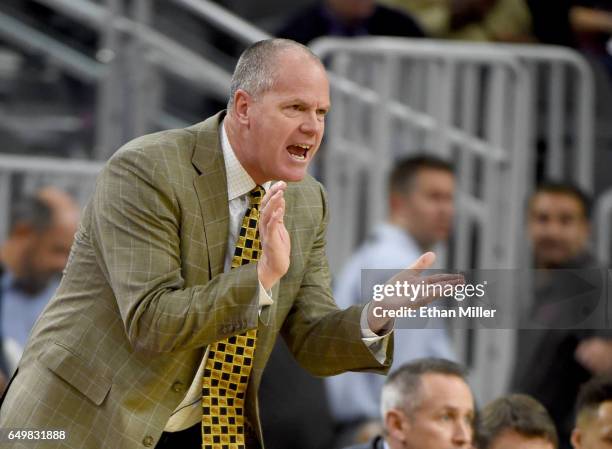 Head coach Tad Boyle of the Colorado Buffaloes gestures to his players during a first-round game of the Pac-12 Basketball Tournament against the...