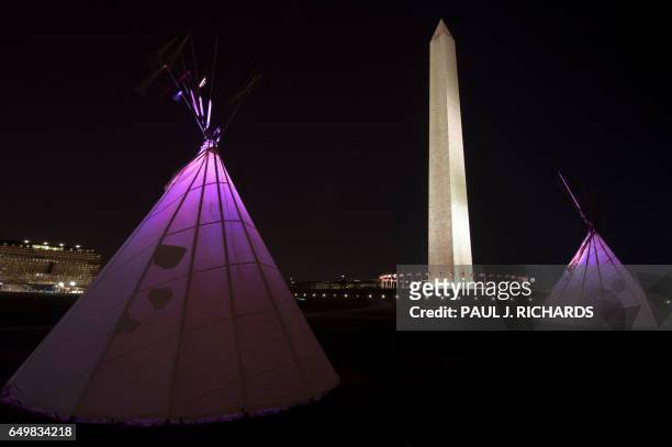 Native American teepees are seen on the National Mall in downtown Washington, DC on March 8 with the National Monument to the rear as tribes from...
