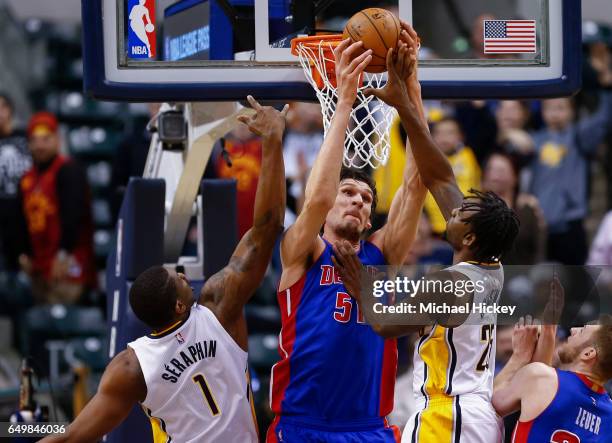 Boban Marjanovic of the Detroit Pistons reaches for the rebound against Kevin Seraphin and Rakeem Christmas of the Indiana Pacers at Bankers Life...