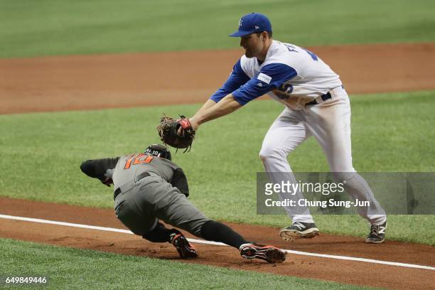 Infielder Jurickson Profar of the Netherlands is tagged out by Infielder Nate Freiman of Israel in the top of the first inning during the World...