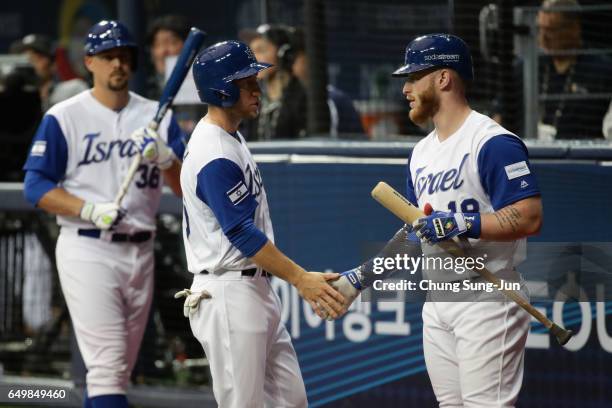 Infielder Ty Kelly of Israel celebrates with his tam mate Outfielder Zach Borenstein after scoring a run by a RBI double of Infielder Nate Freiman of...