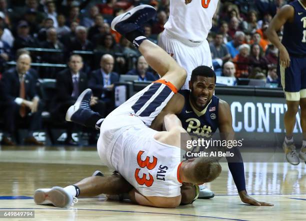 Sheldon Jeter of the Pittsburgh Panthers and Jack Salt of the Virginia Cavaliers collide during the second round of the ACC Basketball Tournament at...
