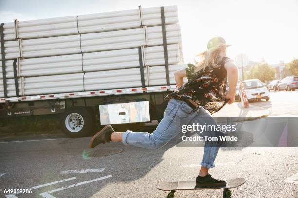 young male skateboarder skates through the empty streets of brooklyn, new york, in the early morning - youth culture speed stock pictures, royalty-free photos & images