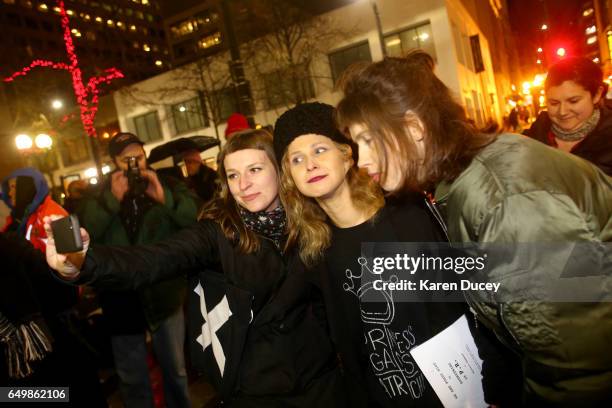 Maria Alyokhina from the feminist rock band Pussy Riot poses for a photo with a fan a rally at Westlake Center on March 8, 2017 in Seattle,...