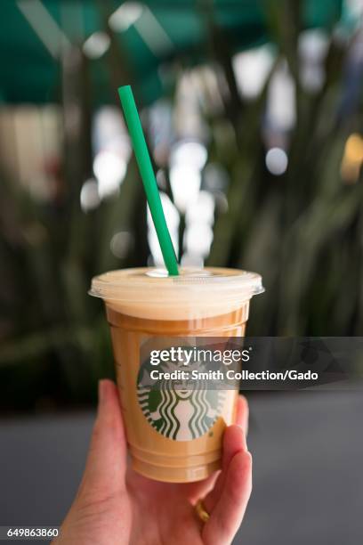 Hand holding a Starbucks Nitro Cold Brew coffee, in the Financial District neighborhood of San Francisco, California, September 26, 2016. Nitro Cold...