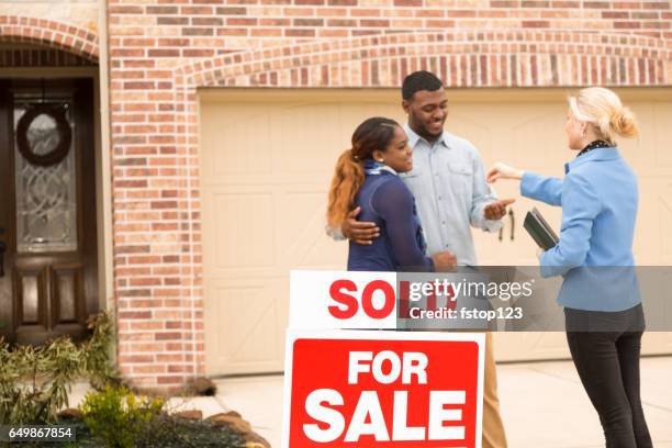 couple receives keys to first home real estate purchase. - brick house door stock pictures, royalty-free photos & images