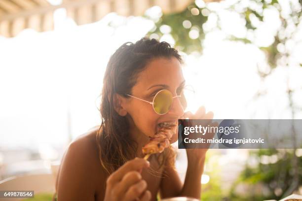 woman eating with hands - chewed stock pictures, royalty-free photos & images