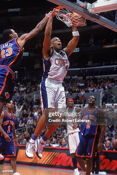 Sean Rooks of the Los Angeles Clippers sinks a slam dunk against Marcus Camby of the New York Knicks during the game at the STAPLES Center in Los...