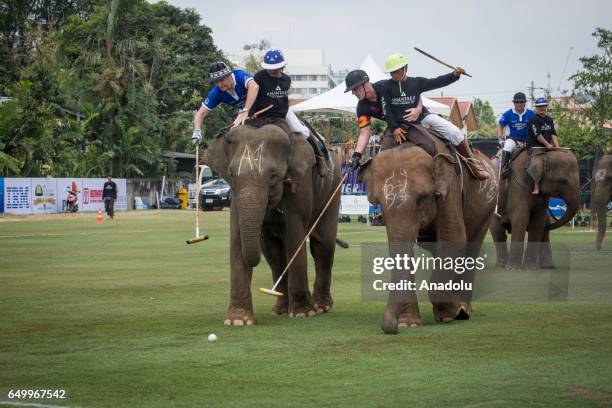 Elephant polo team battle for the ball during a match at the 2017 King's Cup Elephant Polo at Anantara Chaopraya Resort in Bangkok, Thailand on March...