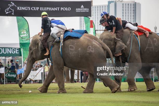 Elephant polo team battle for the ball during a match at the 2017 King's Cup Elephant Polo at Anantara Chaopraya Resort in Bangkok, Thailand on March...