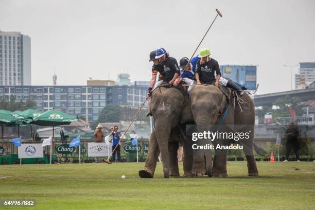 Elephant polo team battle for the ball during a match at the 2017 King's Cup Elephant Polo at Anantara Chaopraya Resort in Bangkok, Thailand on March...