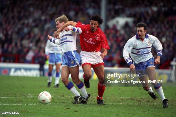 Nottingham Forest's Jason Lee holds back Luton Town's Julian James while John Dreyer, also of Luton Town, looks on.