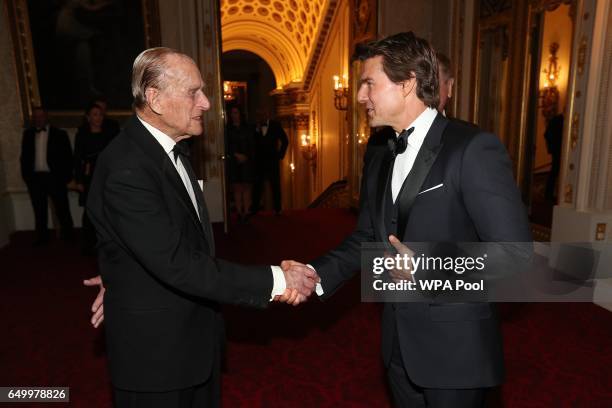 Prince Philip, Duke of Edinburgh and Tom Cruise meet during a dinner to mark the 75th anniversary of the Outward Bound Trust at Buckingham Palace on...