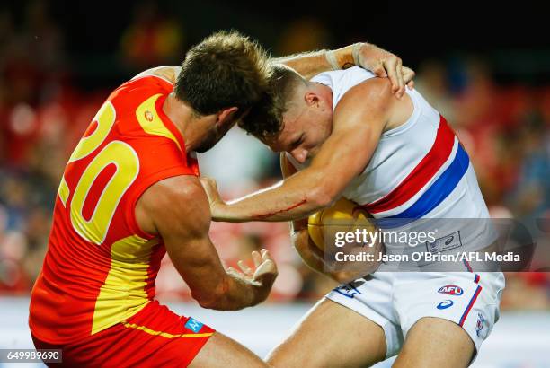 Jake Stringer of the Bulldogs is tackled by Kade Kolodjashnij of the suns during the JLTR Community Series AFL match between the Gold Coast Suns and...
