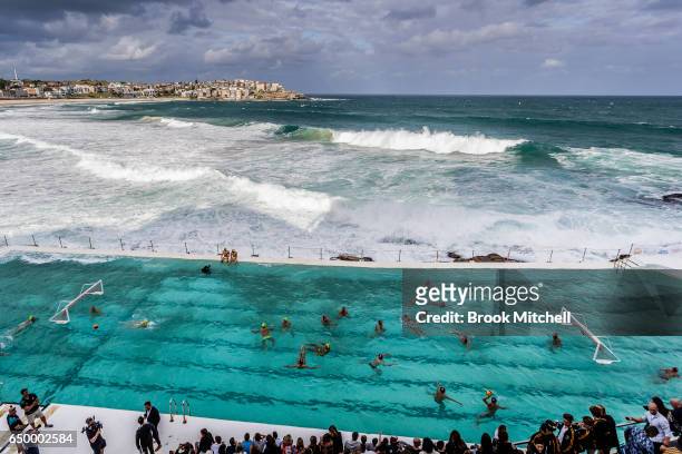 The Olympic Aussie Sharks warm up for their match against an International All-Stars team at Water Polo by the Sea at the iconic Bondi Icebergs on...