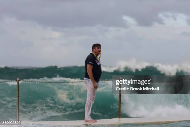 The referee at Water Polo by the Sea watches on as huge waves loom behind him during the Olympic Aussie Sharks match against an International...