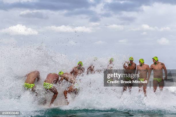 The Olympic Aussie Sharks team is smashed by a large wave before the start of Water Polo by the Sea at Bondi Icebergs on March 9, 2017 in Sydney,...