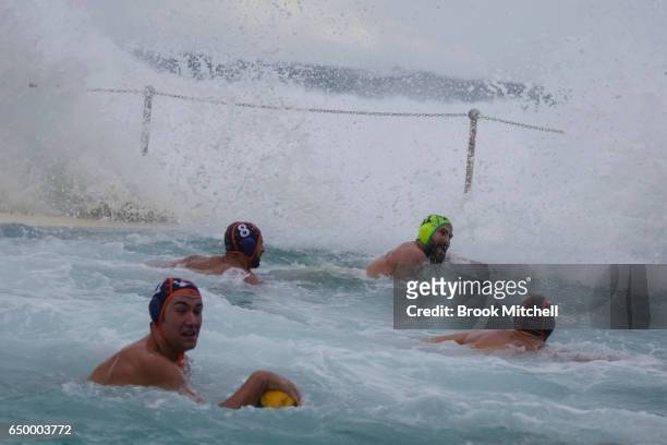 Players brace for a large wave at Water Polo by the Sea at Bondi Icebergs on March 9, 2017 in Sydney, Australia.