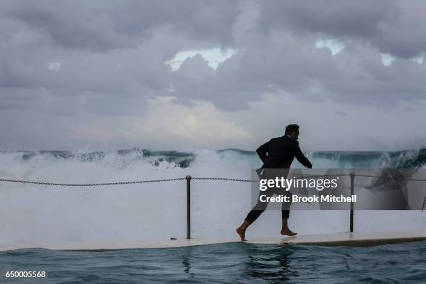 The MC runs for shelter during Water Polo by the Sea at Bondi Icebergs on March 9, 2017 in Sydney, Australia.