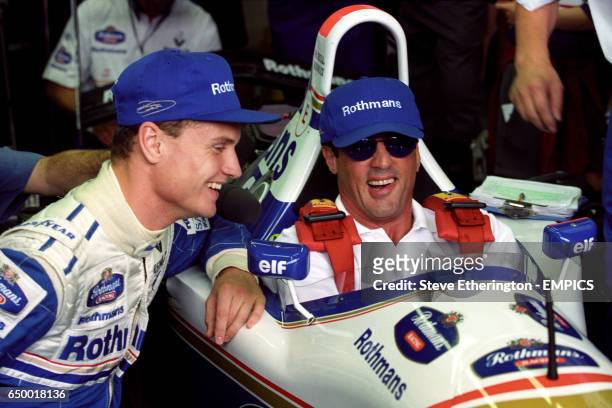 DAVID COULTHARD SHOWS ACTOR SYLVESTER STALLONE THE ROTHMANS WILLIAMS FORMULA ONE CAR