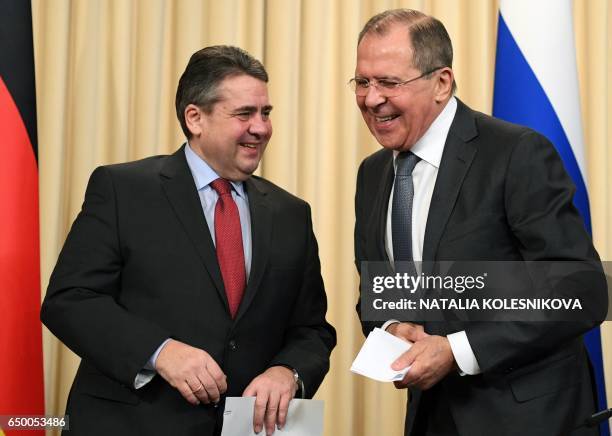 Russian Foreign Minister Sergei Lavrov and his German counterpart Sigmar Gabriel smile after a press conference in Moscow on March 9, 2017. / AFP...