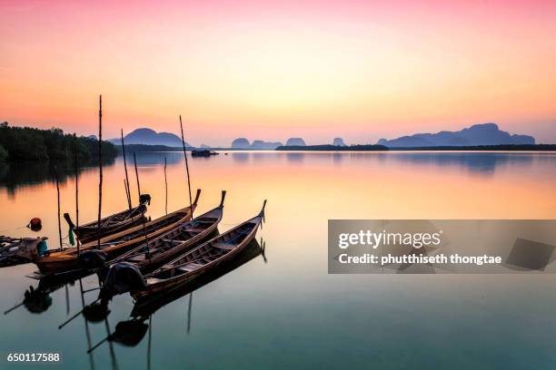 wooden boats in the sea at sunset, phuket,thailand. - phuket - fotografias e filmes do acervo