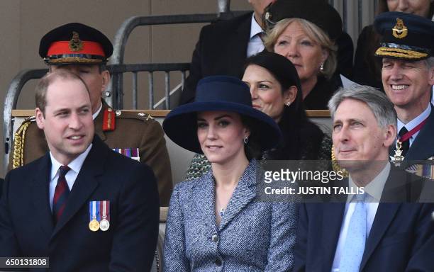 Britain's Prince William, Duke of Cambridge, , Britain's Catherine, Duchess of Cambridge, and British Chancellor of the Exchequer Philip Hammond...