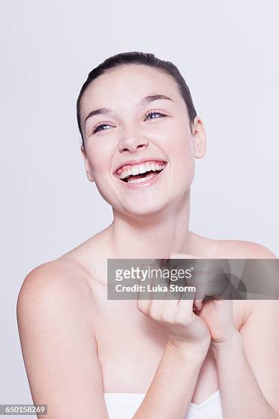 head and shoulder shot of beautiful young woman laughing - natural portrait studio shot white background stock-fotos und bilder