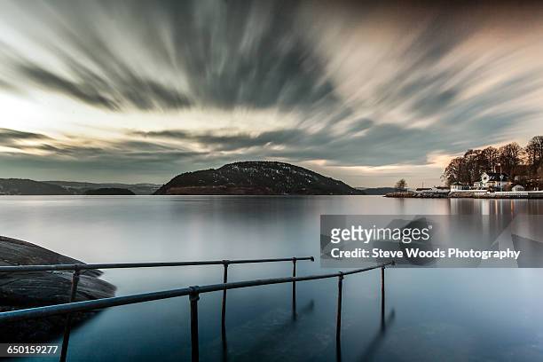 railings submerged in water, oscarsborg, drobak, norway - østfold stock pictures, royalty-free photos & images