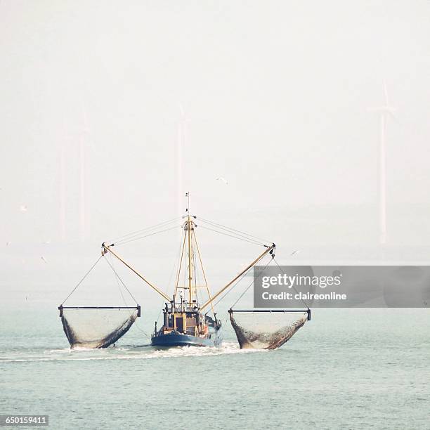 fishing trawler at sea - net fishing stock pictures, royalty-free photos & images