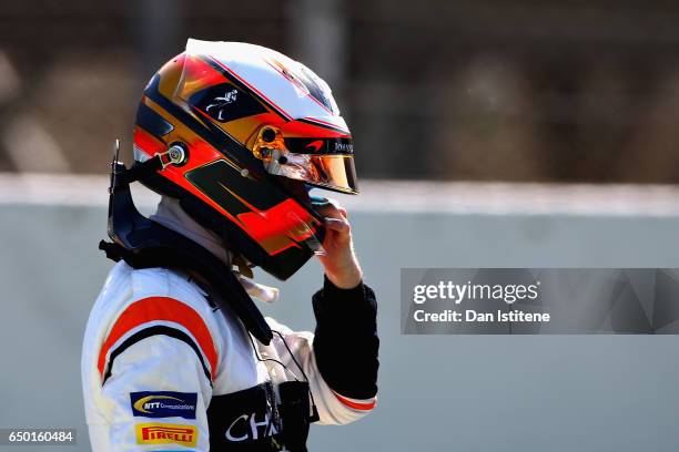 Stoffel Vandoorne of Belgium and McLaren Honda looks on after his car stopped on track during day three of Formula One winter testing at Circuit de...